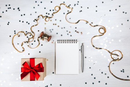 Holiday decorations and notebook with on white rustic table, flat lay style. Planning concept.の写真素材