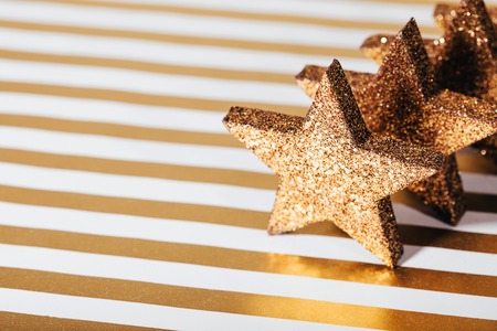 Group of textured glittering golden stars on festive background.の写真素材