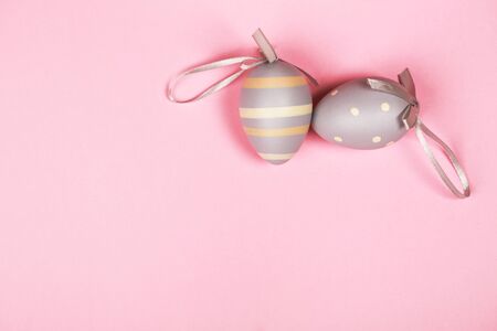 Two colorful Easter eggs on pink backgroundの写真素材