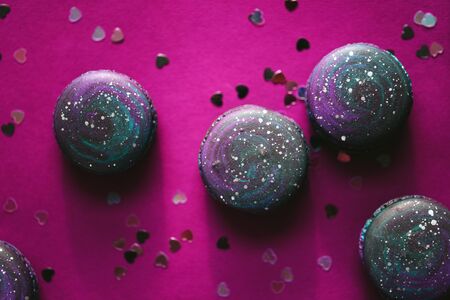 Dark macaroons on purple backgroundの写真素材