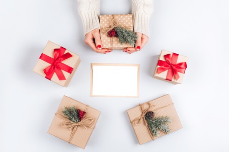 Womans hands and three Christmas gift boxesの写真素材