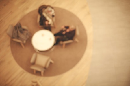 Blurred table with armchairs in cafe