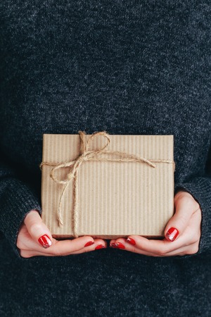 Womans hands holding craft gift boxの写真素材
