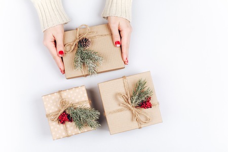 Womans hands and three Christmas gift boxesの写真素材