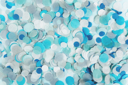 Blue confetti on blue pastel backgroundの写真素材