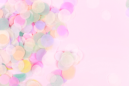 Vibrant confetti on pastel pink backgroundの写真素材