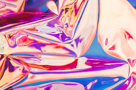 Bright holographic foil background. Multicolored and pastel trendy backdrop.の写真素材