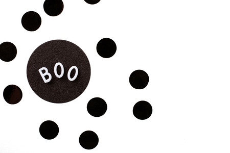Word Boo with black circle black confetti. Halloween concept. Flat lay style isolated on the white background. Place for text.の写真素材