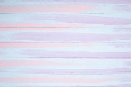 White, blue and pink painted lined on wooden background. Top view.の写真素材