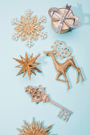 Golden beautiful sparkling christmas decoration on pastel blue background. Place for text. Festive concept.の写真素材
