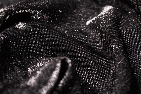 Black and silver background of festive material with wavy folds. Party concept.の写真素材