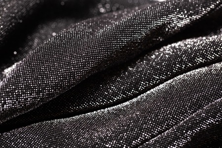 Black and silver background of festive material with wavy folds. Party concept.の写真素材