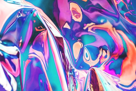 Bright holographic foil background. Multicolored and pastel trendy backdrop.の写真素材