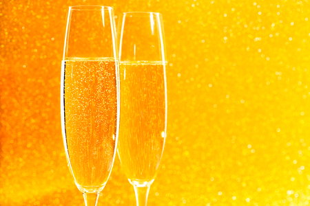 Two glasses of champagne on golden sparkling background.Christmas coming concept.の写真素材