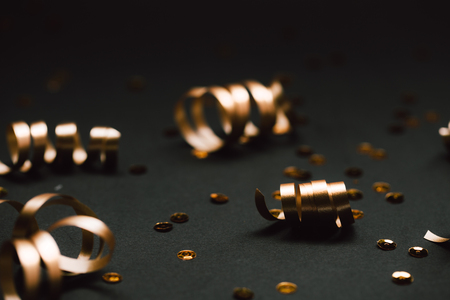 Minimalistic golden decor on black background. Selective focus. Festive concept.の写真素材