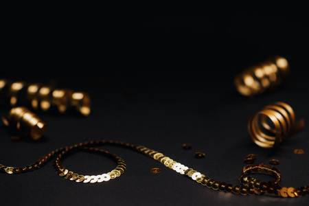 Minimalistic golden decor on black background. Selective focus. Festive concept.の写真素材
