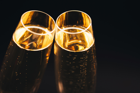 Two glasses of champagne on black stylish background. Top view, place for text. Festive concept.の写真素材