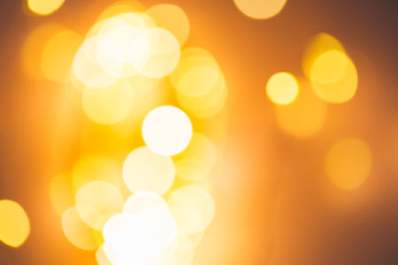 Blurred golden festive lights. Christmas time concept. Perfect new year backdrop. Party concept.の写真素材
