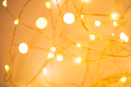 Blurred golden festive lights. Christmas time concept. Perfect new year backdrop. Party concept.の写真素材