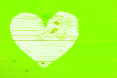 Heart shape of natural wooden background surrounding freshly painted ufo green surface. Renovation concept.の写真素材