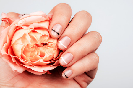 Hand with trendy manicure with Living Coral roseの写真素材