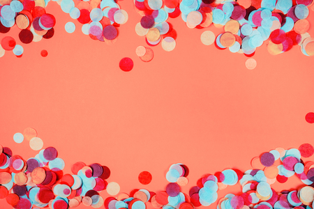 Multicolored festive confetti as a frame Flat lay style. Ispired by color of the year 2019 - Living Coral.の写真素材