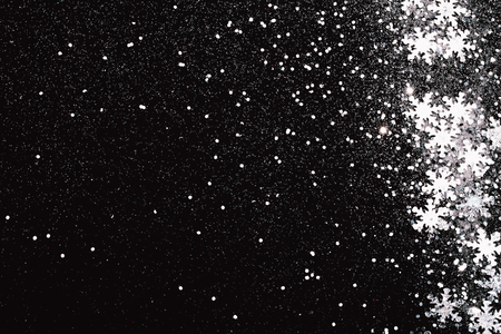 Silver snowflakes on abstract winter black background. Holiday concept. Place for text.の写真素材