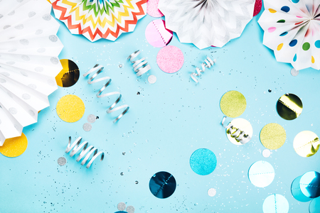 Birthday party on blue background. Flat lay style. Festive multicolored decorationsの写真素材