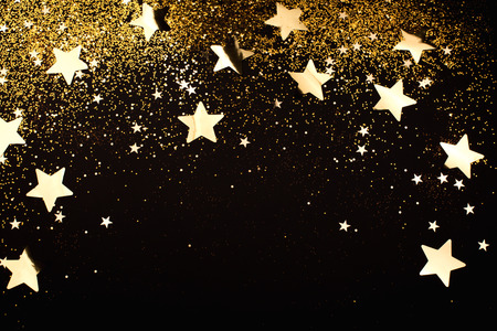 Gold falling sparkles on black background. Festive concept.の写真素材