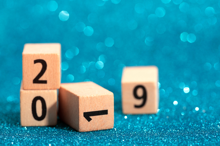 Numbers of 2019 are lying down on blue sparkling background. Festive concept.の写真素材