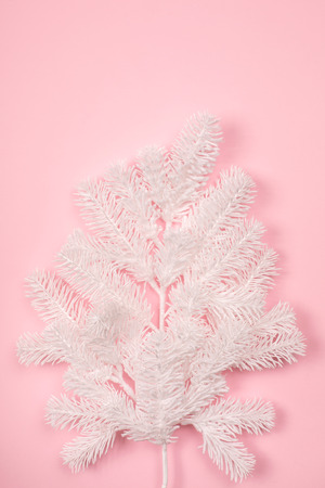 White new year fir-tree on pastel pink background. Top view. Festive concept.の写真素材