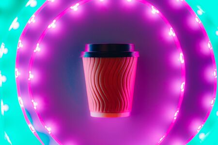 Coffee to go craft cup circling in led neon light. Eco concept.の写真素材