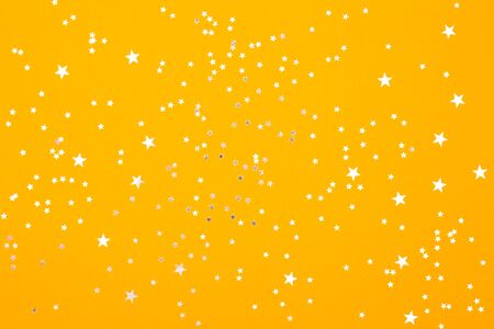 White stars on yellow bright background. Festive backdropの写真素材