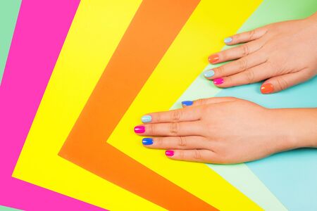 Neon manicure on multicolored bright background in trendy colors. Flat lay style.の写真素材