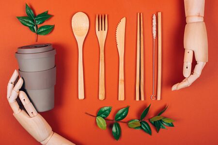 Wooden hand holding reusable picnic tableware. Concept of plastic-free and zero waste livingの写真素材