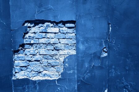 Cracked and textured blue wall, plaster background. Color of the year 2020 concept.の写真素材