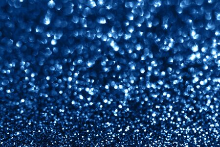 Glamour blue sparkling background. Blured glitter background with blinking stars. Holiday abstract texture.の写真素材