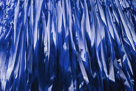 Strips of plastic form a blue trendy background.の写真素材