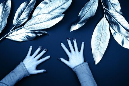 Blue hands with perfect manicure. Demonstrating of color 2020.の写真素材