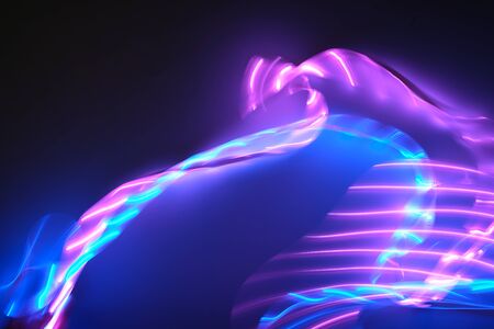 Abstract background of purple and blue neon lights in motion. Backdrop for your design.の写真素材