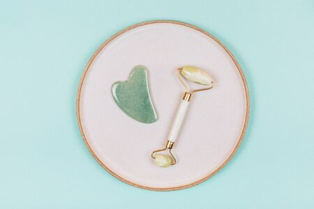 Facial massage kit. Face roller and gua sha massager made from natural stones.の写真素材