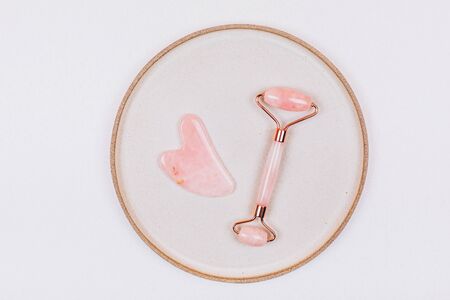Facial massage kit. Face roller and gua sha massager made from natural stones.の写真素材