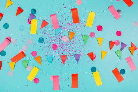 Multicolored paper flags on blue background. Festive concept.の写真素材