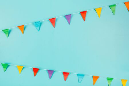 Multicolored paper flags on blue background. Festive concept.の写真素材