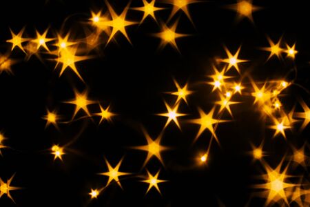 Splash of golden stars on black background.の写真素材
