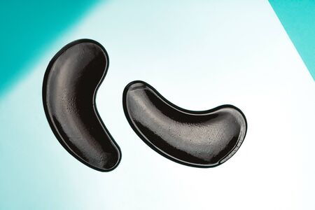 Black eye patches with collagen on bright backgroundの写真素材