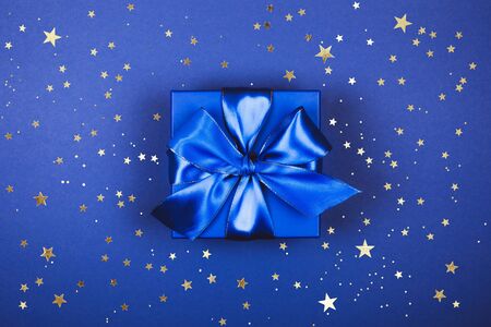 Blue present box with bow in monochrome trendy flat lay compositionの写真素材