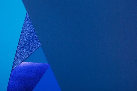 Divided in several parts blue paper background with metallic elemments. Inspired by color of the year 2020の写真素材