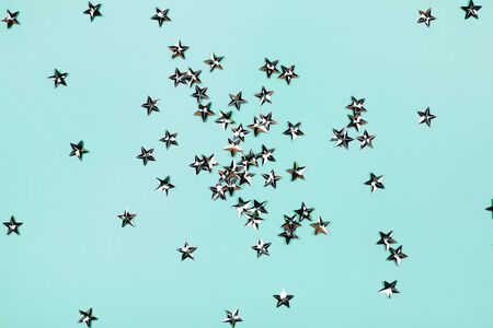 Silver flying stars on blue holiday background. Festive backdrop for your projects.の写真素材