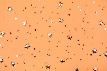 Falling golden stars glitter on pink background. Festive holiday pastel backdrop.の写真素材